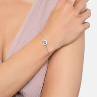 Silver gemstone bracelet on wrist, pink center stone with halo