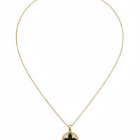 Gold chain necklace with small round clover charm, black center and gold frame