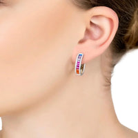 Silver rainbow baguette hoop earrings worn on ear with multicolor gemstone band