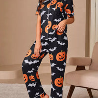 Black pajama lounge set with orange pumpkins and bats, short-sleeve button top and pants