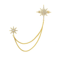 Gold starburst brooch with pin and two dangling chain loops