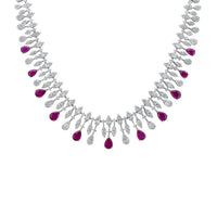 Silver statement necklace with purple teardrop gems and small clear stones.