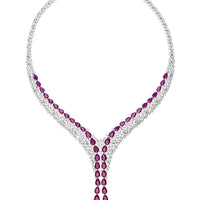 Silver statement necklace with ruby red stones and a dangling teardrop pendant
