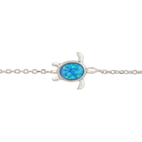 Silver-tone turtle charm bracelet with blue oval opalite stone close-up