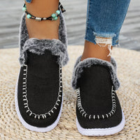 Black faux fur lined round toe slip-on shoes with fuzzy collar and white stitching
