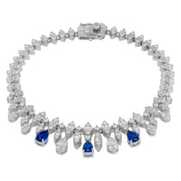 Silver tennis bracelet with crystal teardrop links and blue gemstone accents