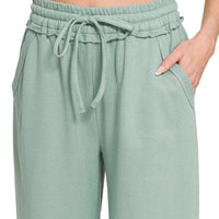 Ash blue wide-leg sweatpants with elastic waist, drawstring ties, and slant pockets