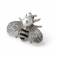 Silver-tone bee brooch with faux pearl center and rhinestone wings