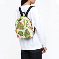 Kids canvas backpack worn by model, green food print and black shoulder straps