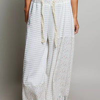 Ivory patchwork knit wide-leg pants with drawstring waist and multicolor speckle panel
