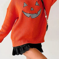 Orange drop-shoulder sweater with jack-o'-lantern face and long sleeves