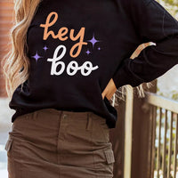 Black Halloween sweatshirt side view with 'hey boo' front graphic and long sleeves