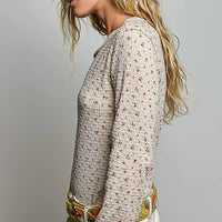 Long-sleeve ribbed knit top with small red mini floral print, side view