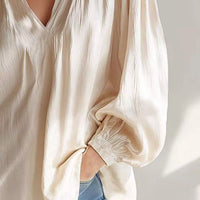 Beige ruffle-trim blouse with V-neck and ruffled long cuff sleeves