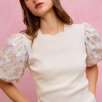 White knit sweater top with floral puff sleeves and ribbed crew neckline