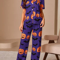 Halloween pajama set: purple button-down short-sleeve top and matching pants with orange pumpkin bat print