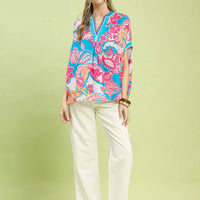 Oversized blue printed top with pink floral paisley, V-neck placket, short sleeves