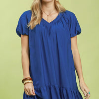 Blue ruffle-hem shift mini dress with V-neck and short puff sleeves.
