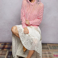 Pink openwork knit top with hooded neckline and long sleeves, high-low hem