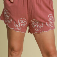 Dusty pink floral embroidered shorts with elastic waistband and scalloped eyelet edge