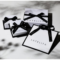 Jewelry gift boxes with black bows and white labels