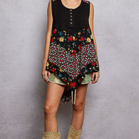 Black ribbed tank top with floral woven patch, button front and asymmetrical hem