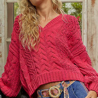 Fuchsia cable-knit cropped V-neck sweater with long puff sleeves and ribbed neckline