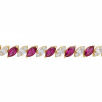 Close-up gold bracelet row with oval ruby-red stones and clear accents
