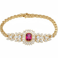 Gold gemstone bracelet with ruby center stone and clear crystal leaf accents