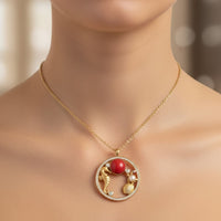 Gold-tone coral bead pendant necklace on chain, round charm with seashell accents