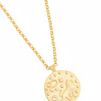 Gold-tone round Leo zodiac pendant necklace, close-up with chain links
