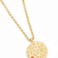 Gold-tone pendant necklace with round zodiac-style charm and orange gemstone