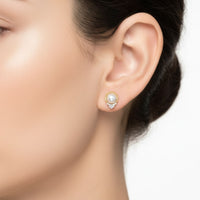 14k gold pearl and diamond earrings on ear, round pearl halo with crystal drop