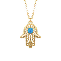 Gold hamsa hand pendant necklace with blue opal-style center stone and filigree frame