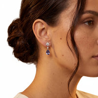 Silver drop earrings on model: crystal starburst and deep blue teardrop dangle
