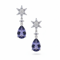 Silver crystal starburst drop earrings with deep blue teardrop stones