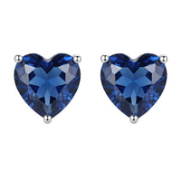 Silver-tone heart-shaped sapphire-blue stud earrings with prong settings