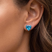 Blue heart gemstone stud earring on ear with silver post and back