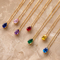 Layered gold chain necklace with multicolor teardrop gem pendants