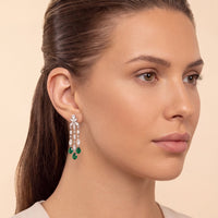 Silver drop earrings with green teardrop stones and dangling crystal-like accents