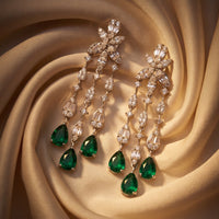 Pair of silver drop earrings with emerald-green teardrop stones and zirconia links
