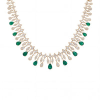 Gold statement necklace with emerald green teardrop gemstones and rhinestone links