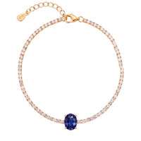 Gold oval gemstone tennis bracelet with sapphire center stone