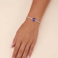 Silver tennis bracelet with oval sapphire gemstone