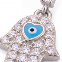 Silver-tone hamsa hand charm with blue enamel eye and sparkling clear stones.
