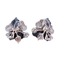 Blue and purple flower stud earrings back view with silver-tone posts and backs.