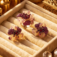 Rhinestone flower stud earrings displayed in a velvet jewelry box, pink and white