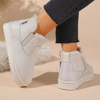 White plush-lined ankle boots showing rear and cushioned insole lining