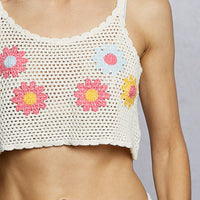 Close-up of ivory crochet cropped cami with multicolor floral embroidery detail