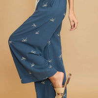 Dusty blue wide-leg drawstring pants with bow embroidery, side view